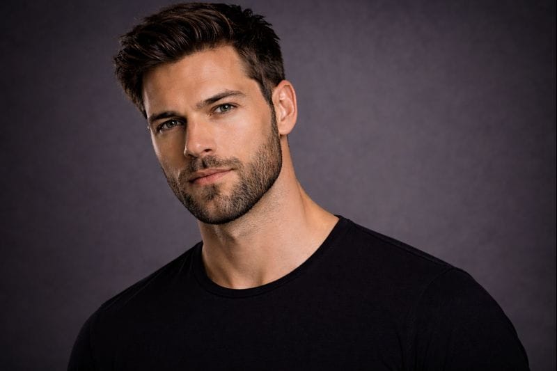 Man with a short beard that is fully formed and trimmed close to the face.